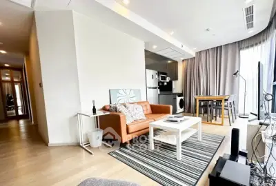 Modern living room with open kitchen, stylish decor, and natural light in a contemporary apartment.