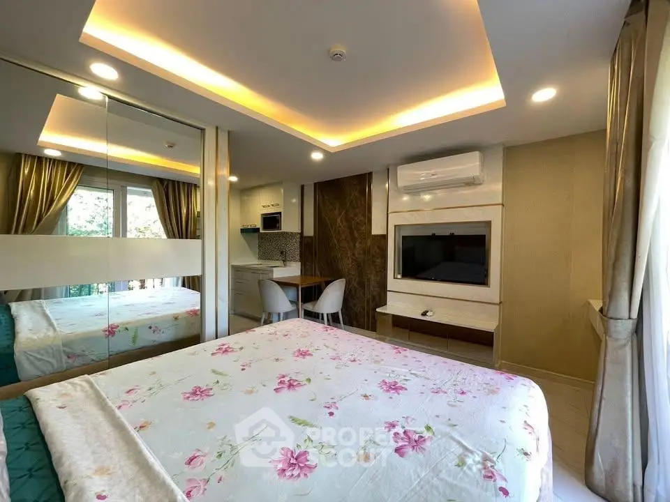 Luxurious bedroom with modern decor, mirrored wardrobe, and ambient lighting