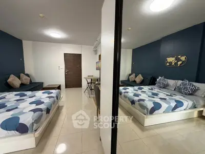 Modern bedroom with stylish decor and cozy seating area, perfect for relaxation and comfort.