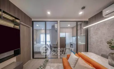 Modern open-plan living room with stylish kitchen and cozy bedroom in a contemporary apartment.
