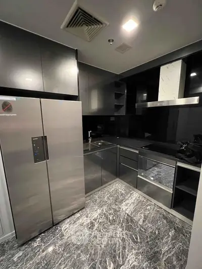 Modern kitchen with sleek black cabinetry and stainless steel appliances