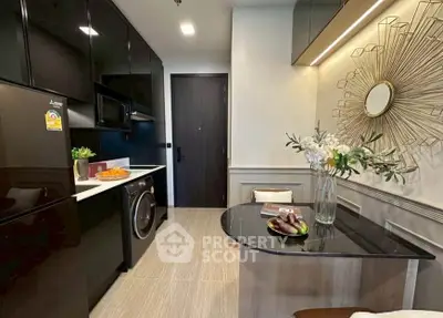 Modern kitchen with sleek black appliances and stylish decor