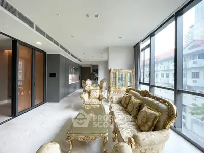 Luxurious living room with elegant furniture and large windows offering city views.