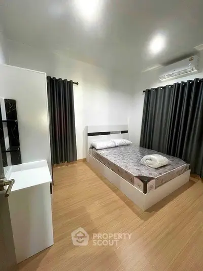 Modern minimalist bedroom with sleek design and cozy ambiance.