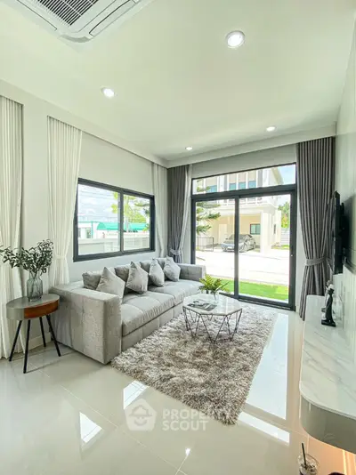Modern living room with large windows and stylish decor
