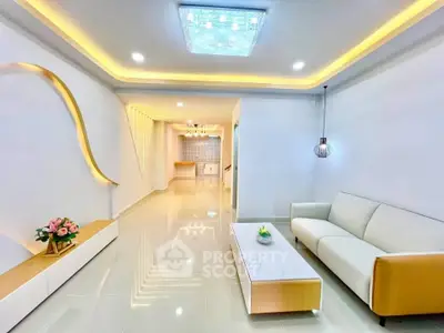 Modern living room with elegant lighting and sleek furniture design.