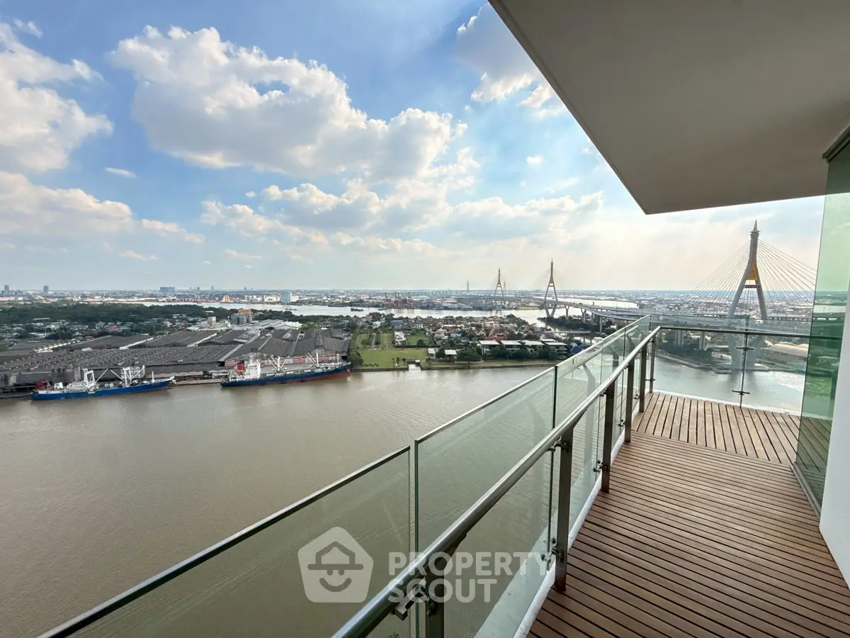 Stunning river view from a spacious balcony with modern glass railing.