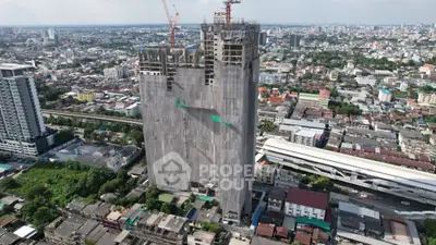 Aerial view of high-rise building under construction in urban cityscape
