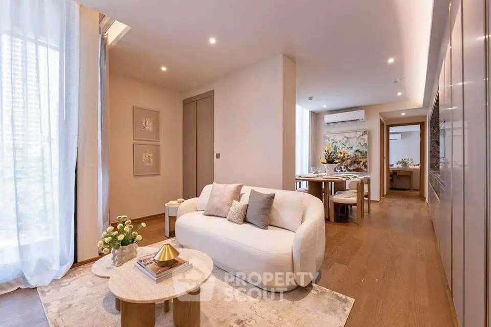 Elegant modern living room with cozy seating and stylish decor in a luxurious apartment.