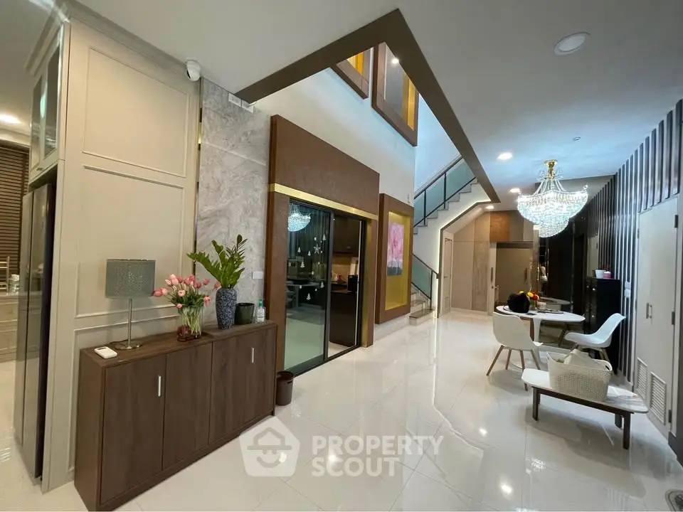Luxurious modern living room with high ceiling and elegant chandelier