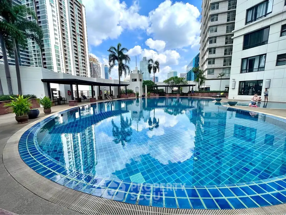 Luxurious high-rise apartment with stunning pool and city views, perfect for urban living.