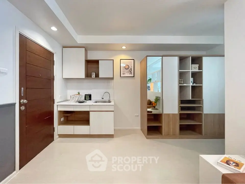 Modern kitchen with sleek cabinetry and open layout in a stylish apartment.