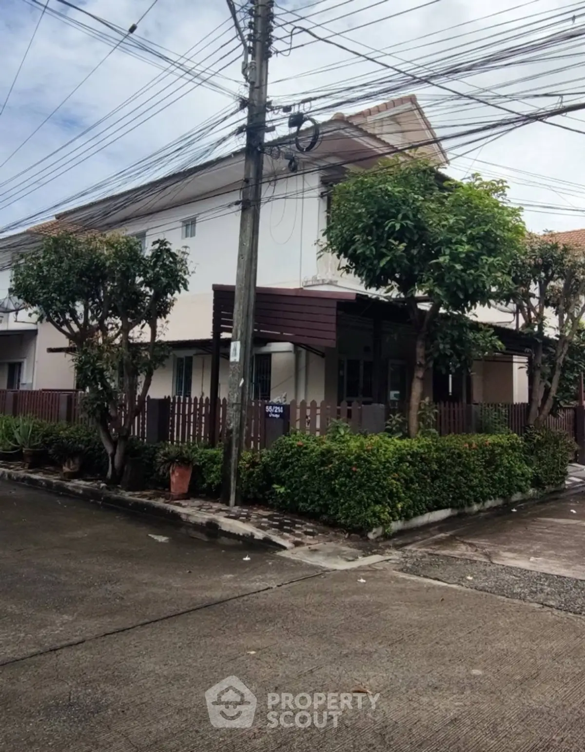 Charming corner unit house with lush garden and modern exterior design.