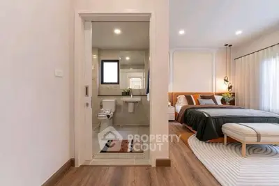 Elegant bedroom with ensuite bathroom, featuring modern decor and cozy ambiance.