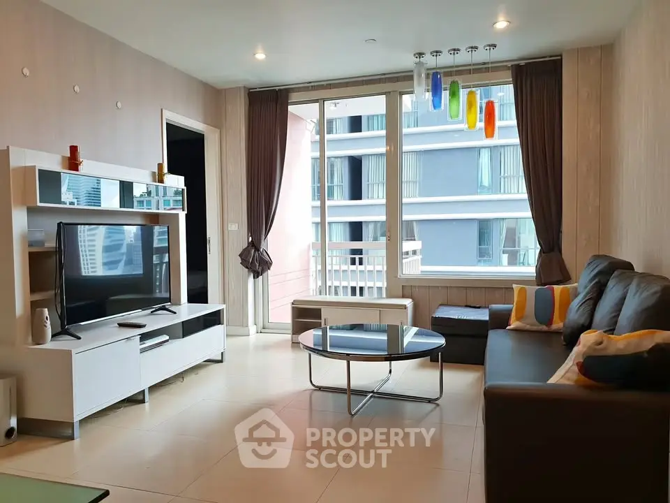 Modern living room with stylish decor and large windows in a contemporary apartment.