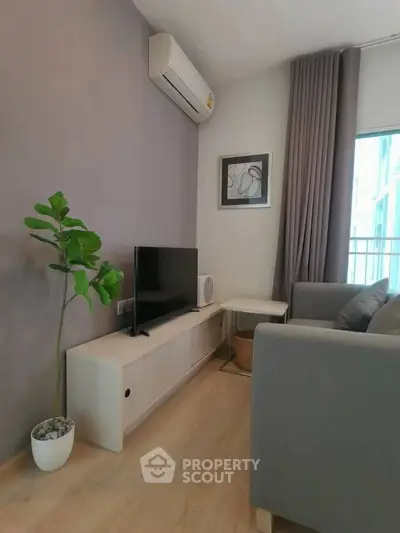 Modern living room with sleek furniture and air conditioning, perfect for relaxation.