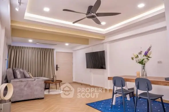 Spacious modern living room with stylish decor and ceiling fan