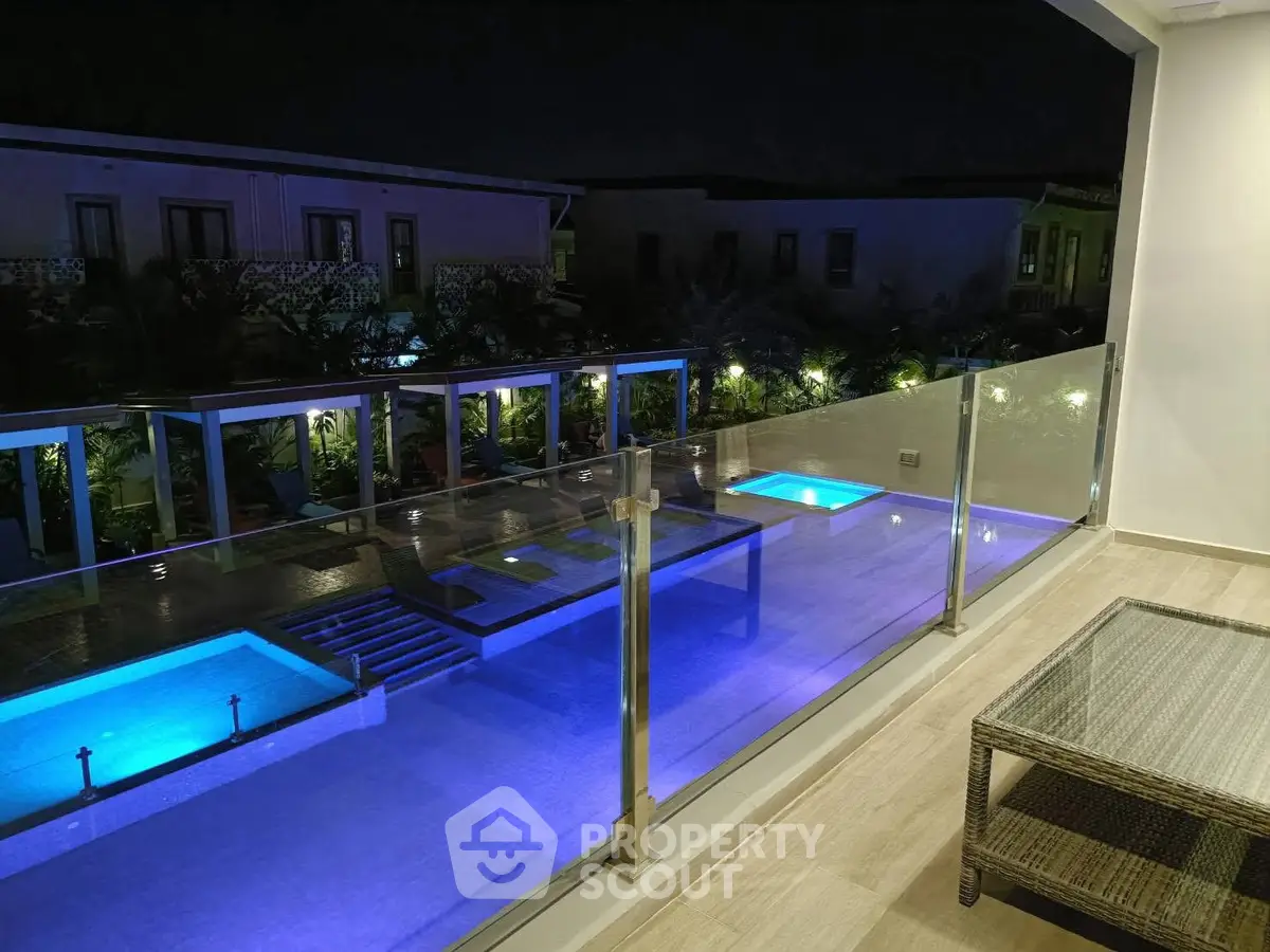 Luxurious night view of illuminated pool from spacious balcony