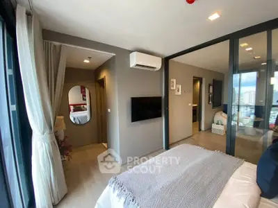 Modern bedroom with city view, featuring sleek design and ample natural light, perfect for urban living.