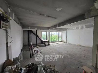 Spacious unfinished room with large windows and city view, ideal for customization.