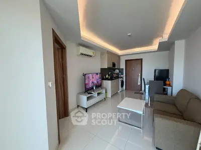 Modern living room with sleek furniture and integrated kitchen appliances