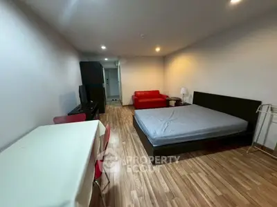 Spacious studio apartment with modern furnishings and wooden flooring