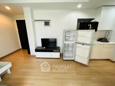 Modern living space with open fridge and sleek furniture