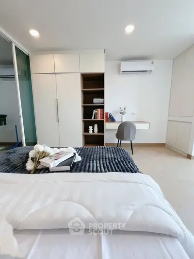 Modern bedroom with sleek storage and cozy decor, perfect for relaxation.