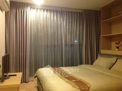 Cozy bedroom with elegant curtains and soft lighting, perfect for relaxation and comfort.