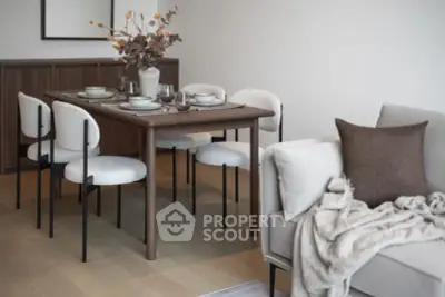 Stylish modern dining area with elegant table and chairs, cozy sofa, and chic decor.