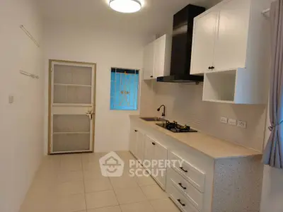 Modern kitchen with sleek cabinetry and gas stove in a bright, minimalist design.