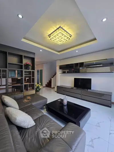 Modern living room with stylish ceiling light and leather sofa