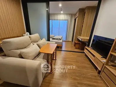 Modern living room with cozy seating and wooden flooring