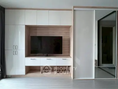 Modern living room with sleek built-in TV cabinet and sliding door wardrobe