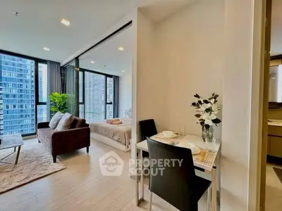 Modern open-plan living room and bedroom with city view in luxury apartment