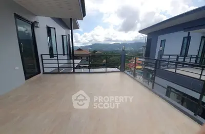 Spacious balcony with stunning mountain views in modern residential building.