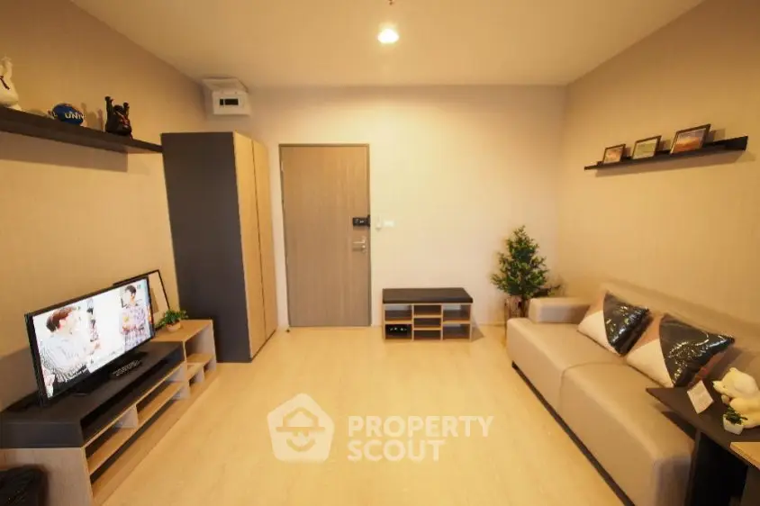 Modern living room with sleek furniture and entertainment center, perfect for relaxation and entertainment.