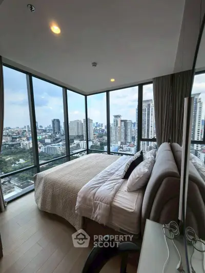 Luxurious bedroom with panoramic city views in a high-rise apartment