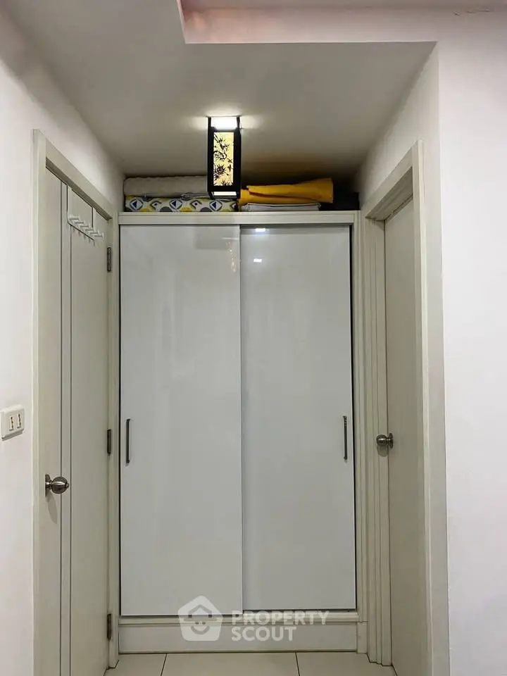 Modern hallway with sleek white storage cabinet and ambient lighting