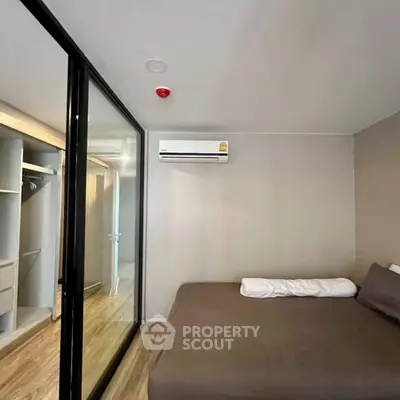 Modern bedroom with glass sliding door and built-in closet