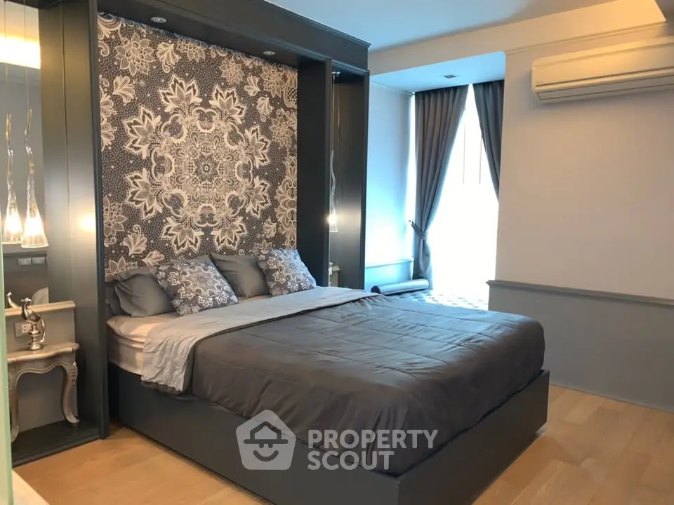 Luxurious bedroom with elegant decor and natural light, featuring a stylish accent wall and modern furnishings.