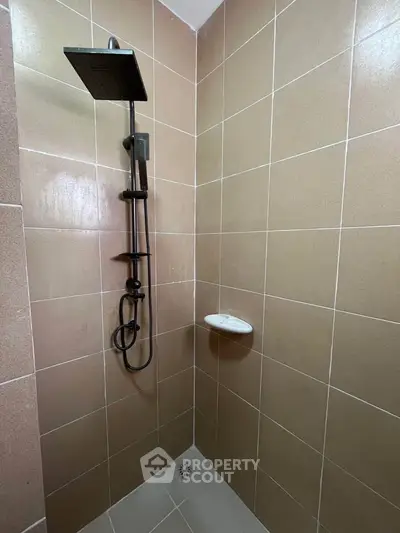 Modern bathroom shower with sleek fixtures and neutral tile design