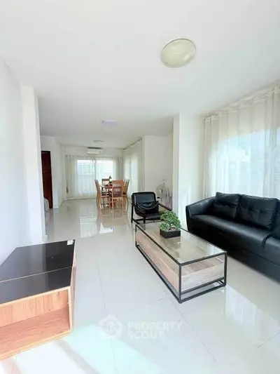 Spacious modern living room with sleek furniture and abundant natural light