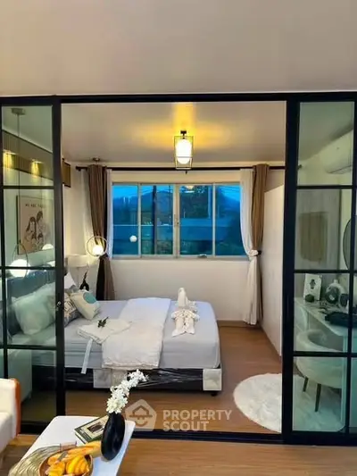 Modern bedroom with glass partition and cozy decor in stylish apartment