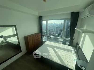 Modern bedroom with city view, large window, and stylish furnishings.