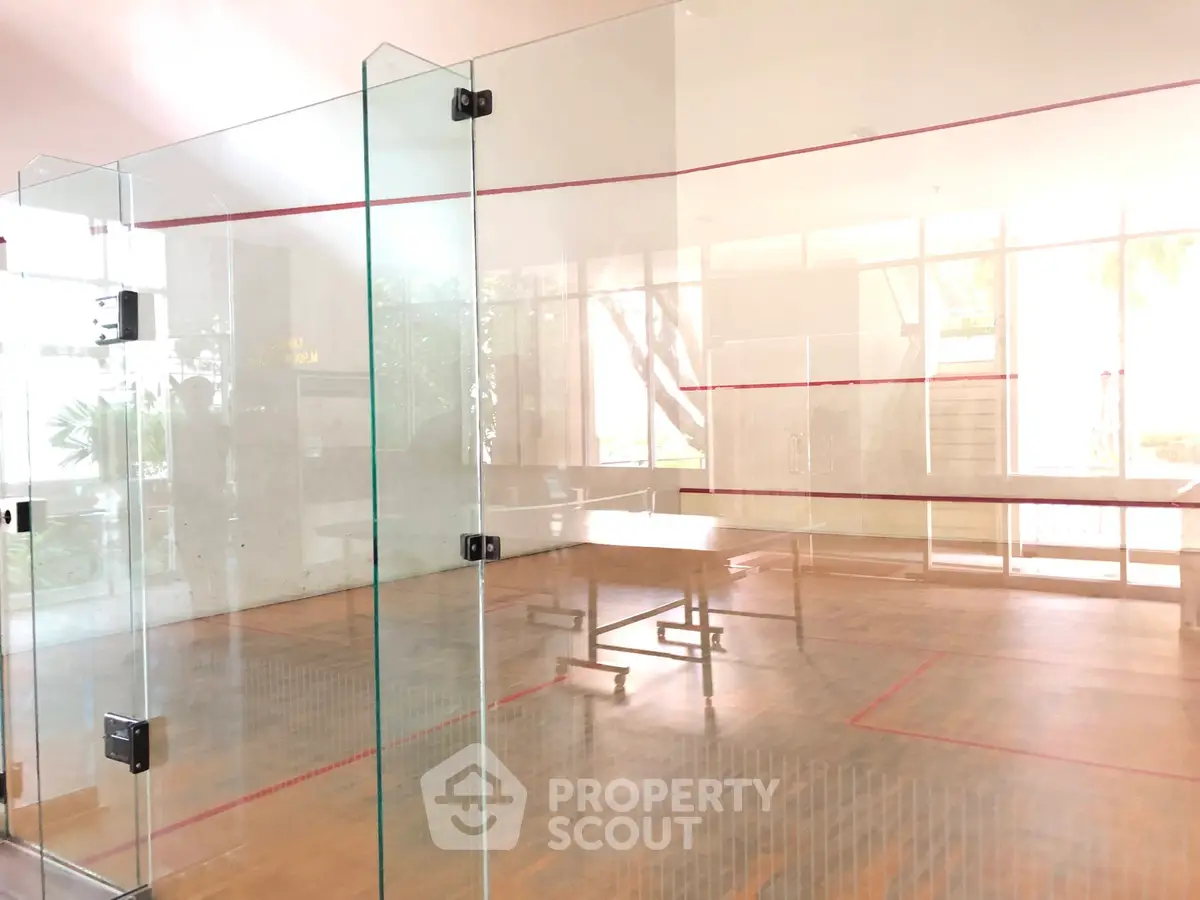 Modern squash court with glass walls in luxury residential building