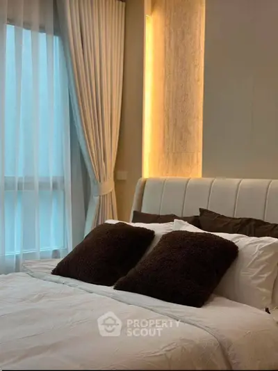 Luxurious bedroom with elegant lighting and plush pillows, perfect for relaxation.