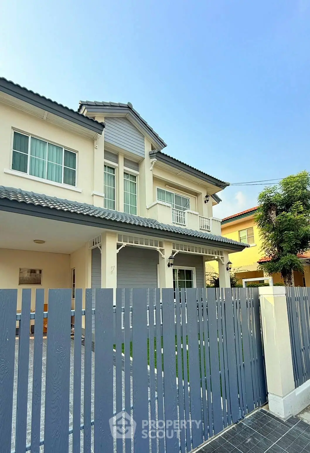 Charming two-story house with modern design and spacious front yard, perfect for family living.