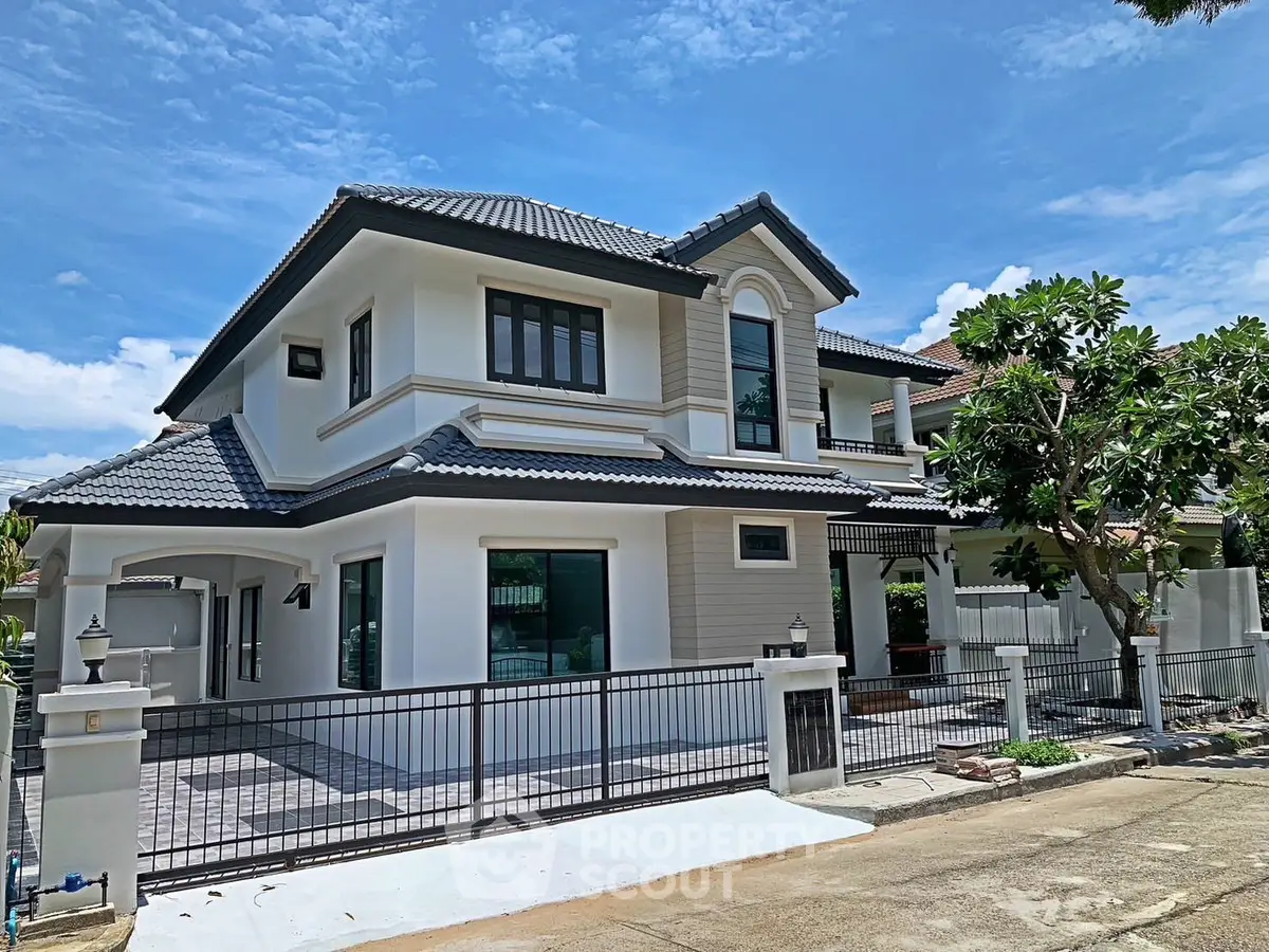 Stunning two-story house with modern design and spacious driveway in a serene neighborhood.