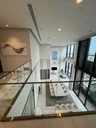 Luxurious modern living room with high ceilings and panoramic city views.